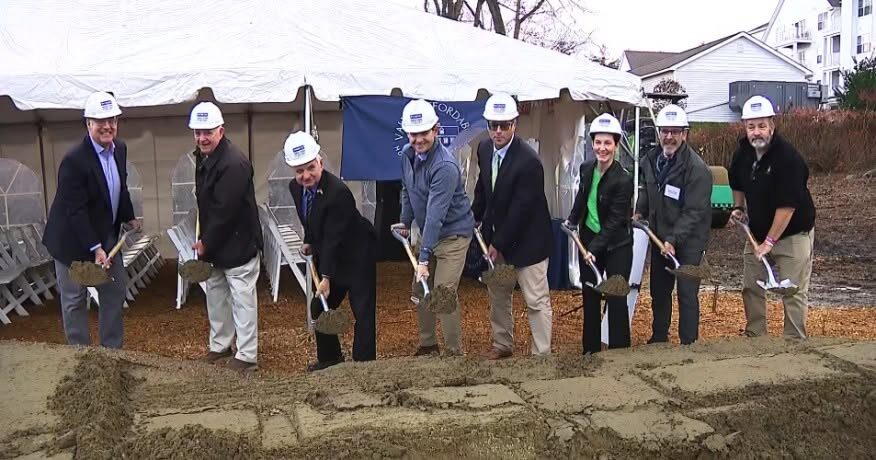 Matt with officials in hard hats breaking ground on a public facility