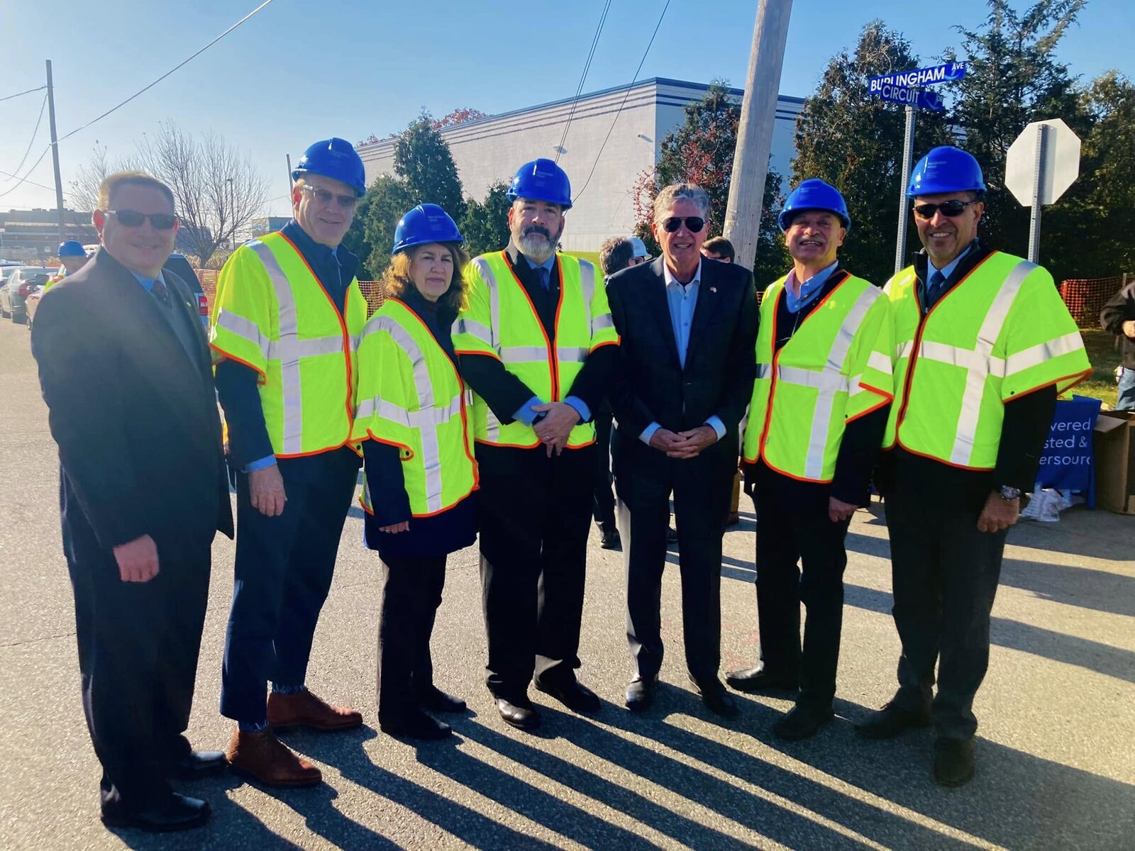 Matt in a safety vest and hard hat with officials on a site visit at Quonset